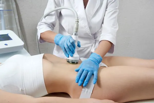 Lost the Weight but Not the Loose Skin? 2 woman having HIFU treatment on her stomach to combat loose skin Folkestone following weight loss